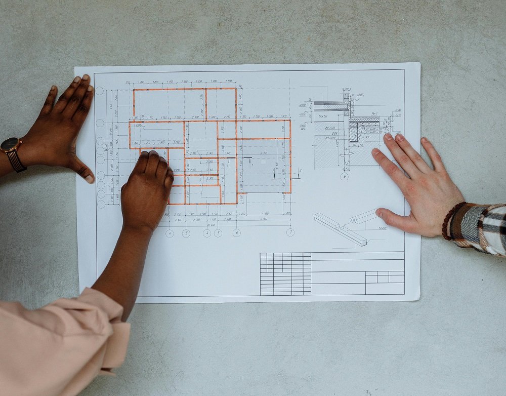 Hands Holding a Floor Plan