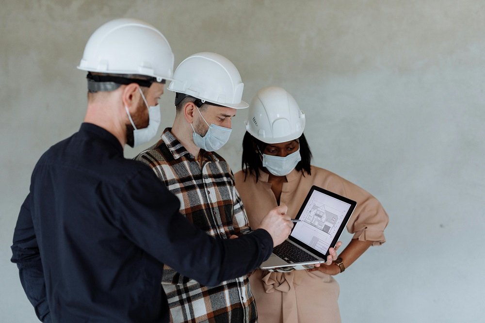 engineers looking at the floor plan on the screen